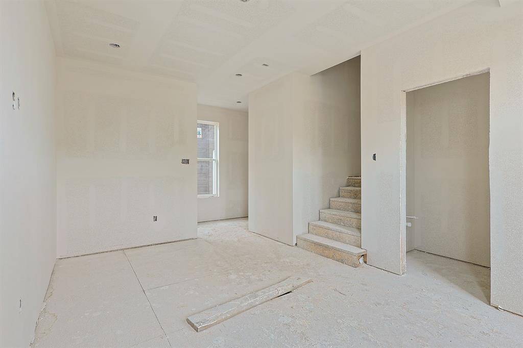 Progress as of June 2025. Tucked toward the back of the home, this bonus room offers flexibility to fit your lifestyle. Whether you envision a dedicated home office, game room, playroom, or creative studio, the space is primed for personalization. Framed and sheetrocked, it's ready for the finishing touches that will bring it to life.