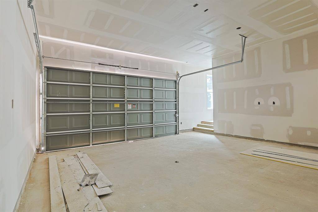 This roomy two-car garage provides ample space for vehicles, storage, and workshop needs. Conveniently located with easy access to the home and driveway, it’s an essential feature for modern living and daily convenience. Ready to be finished and tailored to your needs!