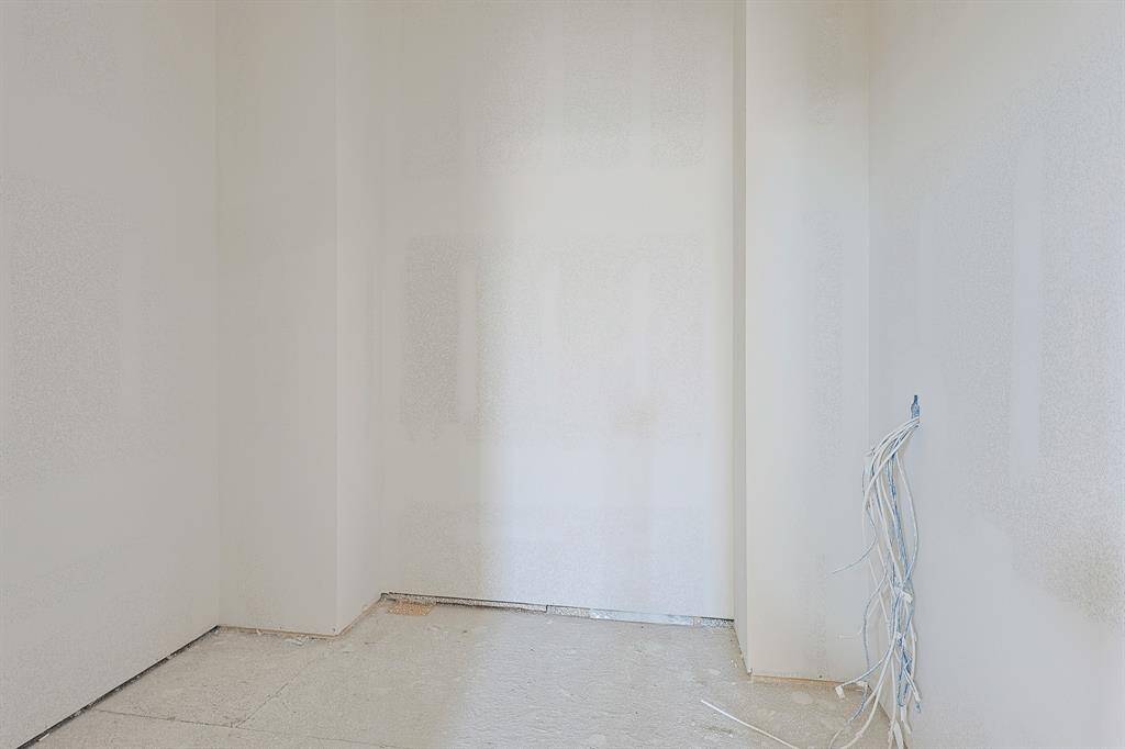 This generous primary closet offers abundant storage and organization potential, designed to accommodate wardrobes of all sizes. With ample room for shelving, hanging space, and more, it completes the primary suite with convenience and style.