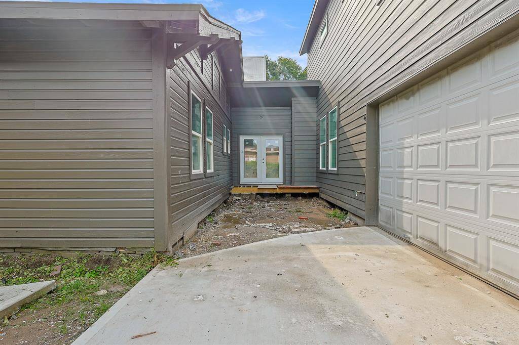 Situated between the front of the home and the rear addition, this hallway features a door leading to a private outdoor porch. This secluded spot offers a peaceful retreat, perfect for enjoying fresh air and quiet moments away from the main living areas.