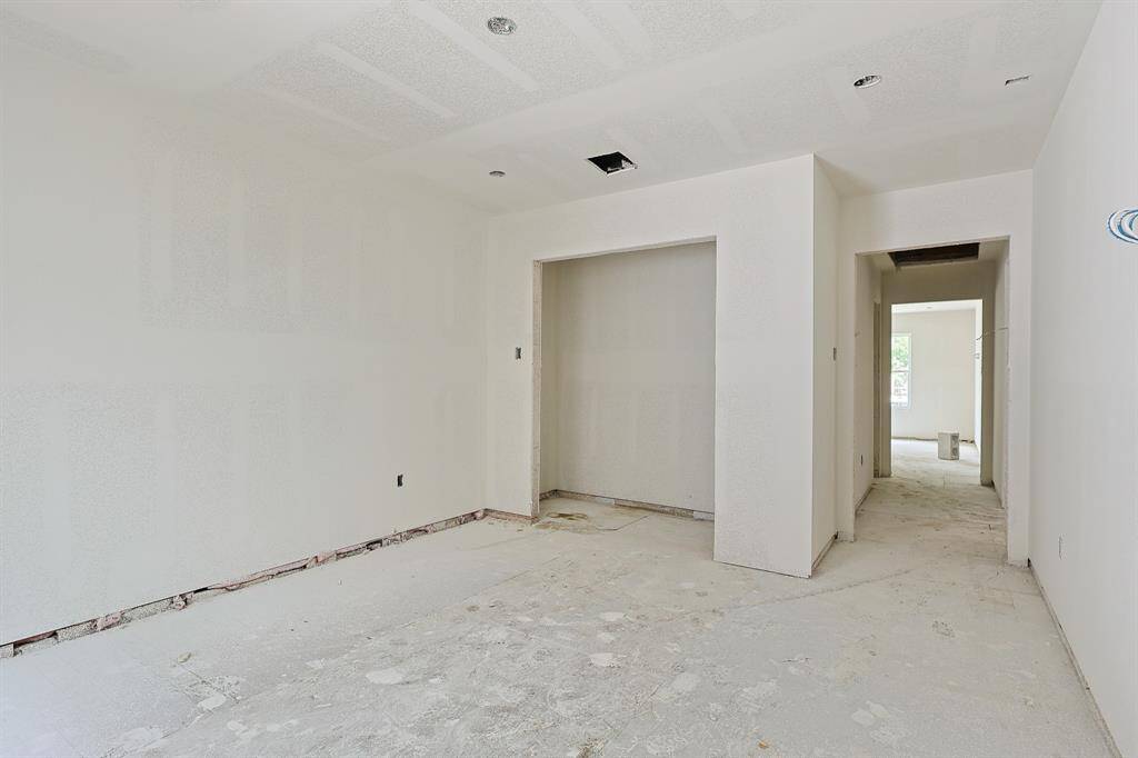 Current progress as of June 2025. Renovation is well underway in this secondary bedroom, currently outfitted with fresh sheetrock and ready for finishing touches. The room will feature a spacious closet—ideal for guests, family, or a stylish home office setup. A clean slate with great potential!
