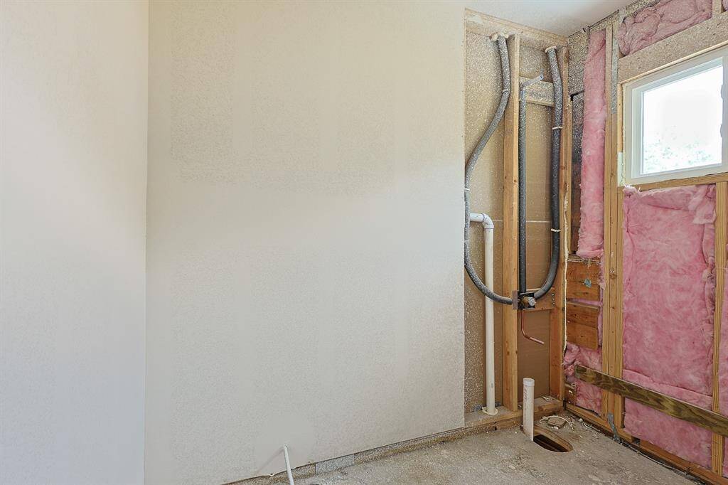 Situated between the secondary bedrooms, this bathroom is taking shape and will soon feature a sleek tub/shower combo—ideal for everyday functionality and guest comfort. Currently in the construction phase, this space will be a stylish and practical addition once complete.