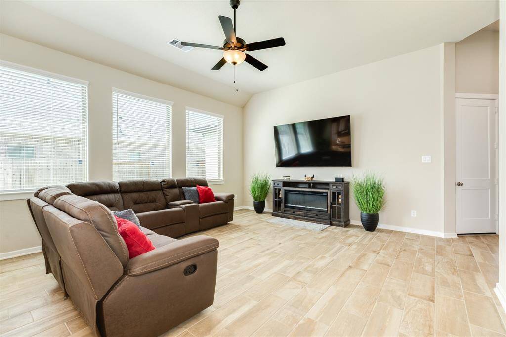 The oversized windows and beautiful tile floors are the highlights of this home, and the tile flooring continues throughout the main living areas. Lots of natural light coming in through the windows.