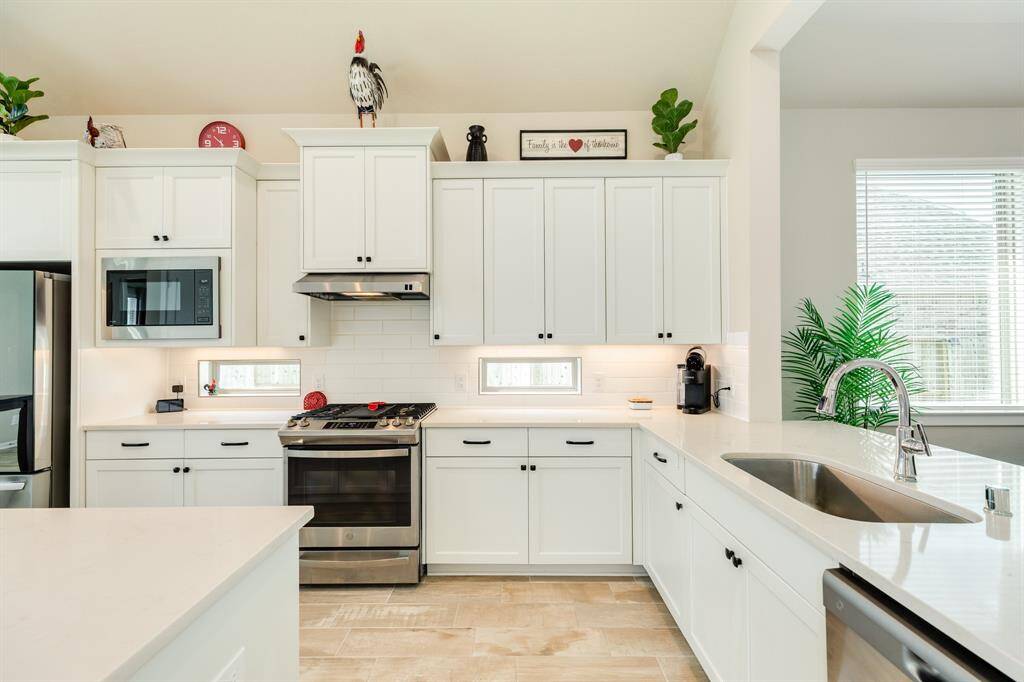 The kitchen is the heart of this delightful home. With its ample natural light and gleaming countertops, it's as bright and beautiful as can be.