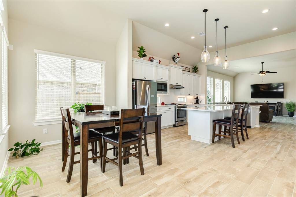 The dining room, kitchen and family room flow seamlessly to create one large entertaining space.
