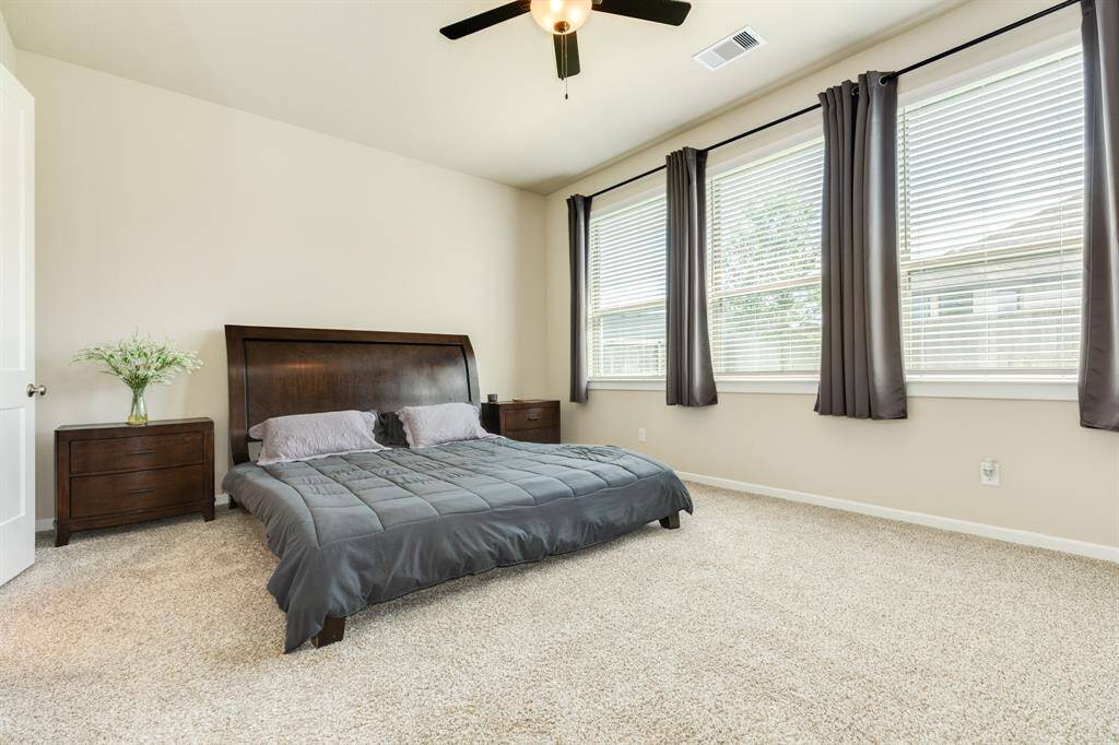 The primary bedroom in this home has spacious, oversized windows, which allows natural light to flow throughout.