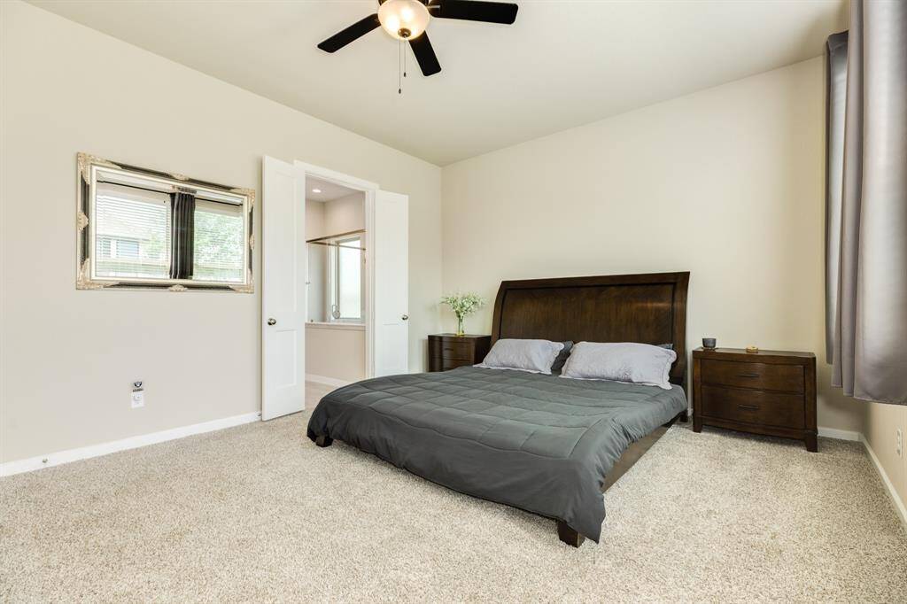 The primary bedroom features double doors leading to the primary bathroom.