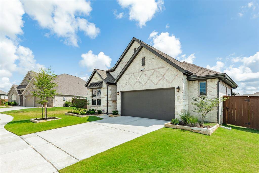 The front of this house is in a classic but stylish style. The beige brick adds an element of sophistication that might be lacking in a plain house. The style is definitely elegant.