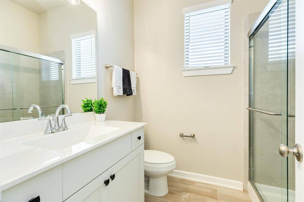 The first bedroom includes a bathroom with glass walk in shower