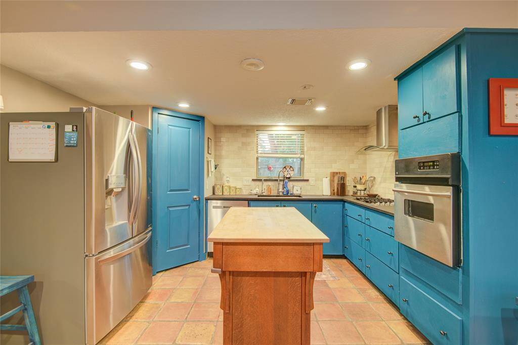 The kitchen offers two spacious walk-in pantries and stainless steel appliances.