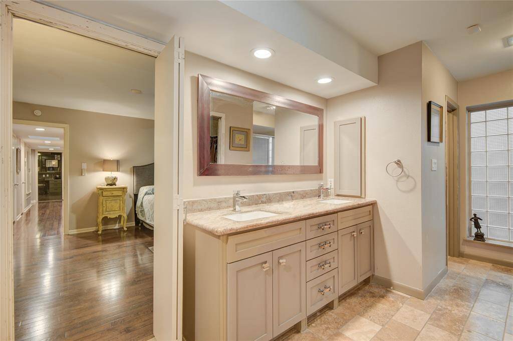 The primary ensuite bath has recessed lighting and a tray ceiling.