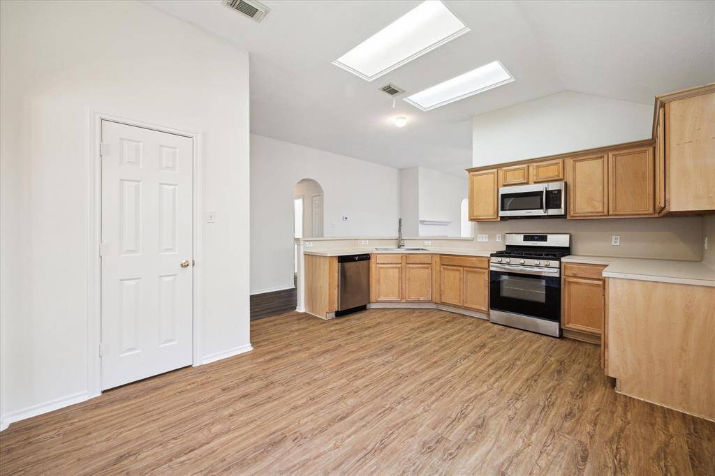 The kitchen is roomy and functional, equipped with a stove and microwave- ready for culinary creativity!