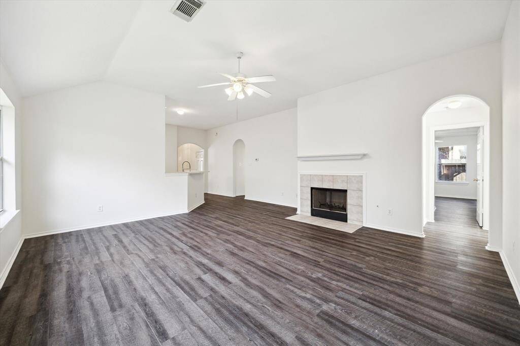 The spacious living room offers excellent flow, creating seamless connection through the home and easy access to a lovely patio