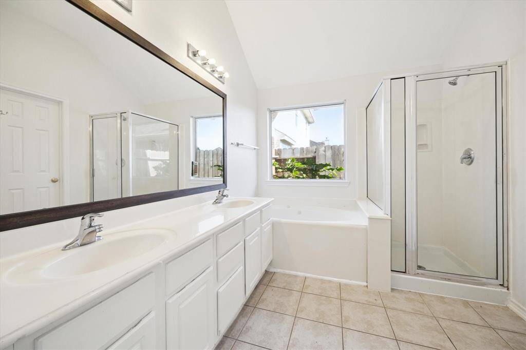 The primary bathroom features a jacuzzi tub and walk-in shower