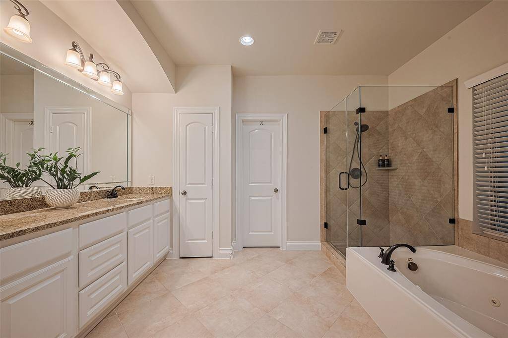 You'll love the spacious primary bathroom, complete with a new frameless shower, separate jetted tub, dual sinks, a linen closet, and an expansive primary closet for ample storage