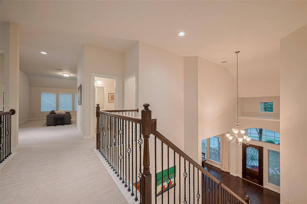 Upstairs landing overlooking the front entry.  Gameroom, media room straight ahead with 1 secondary bedroom to the right