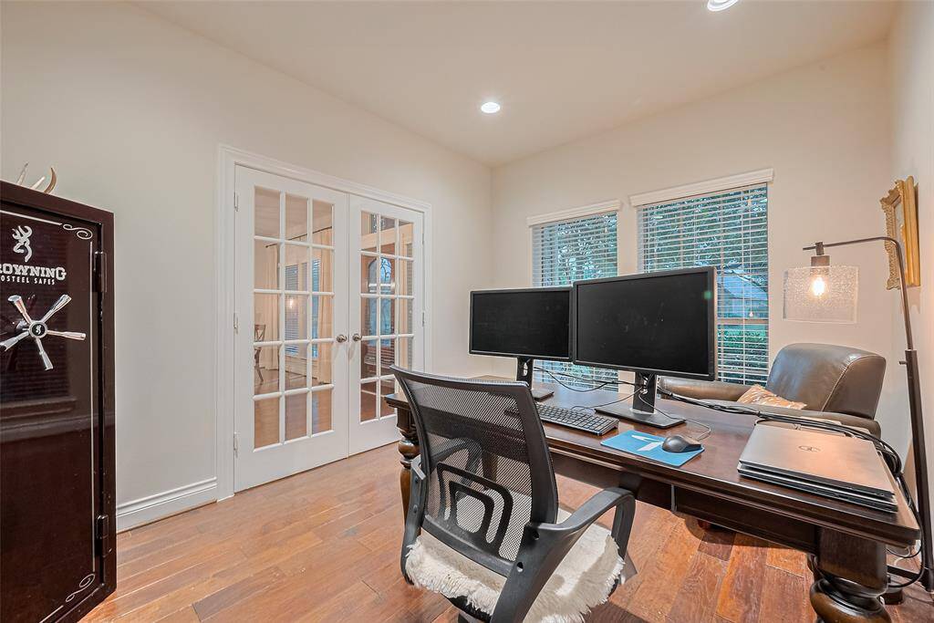 Just off the entry and tucked behind elegant French doors, a dedicated office offers a quiet workspace — easily adaptable as a second living area or music room to suit your needs