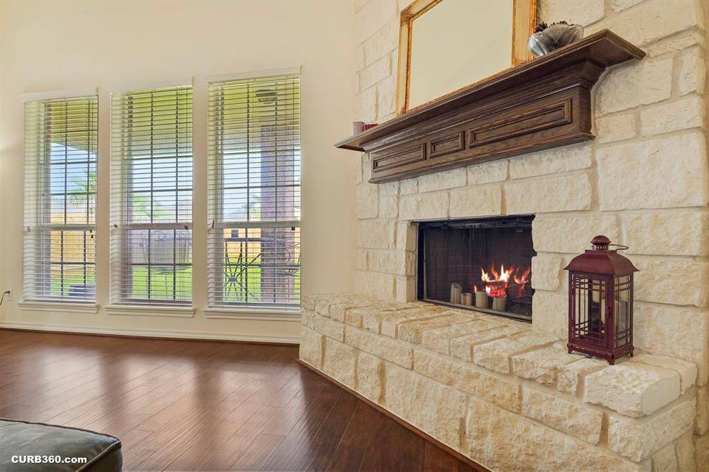 stone fireplace with a wooden mantel