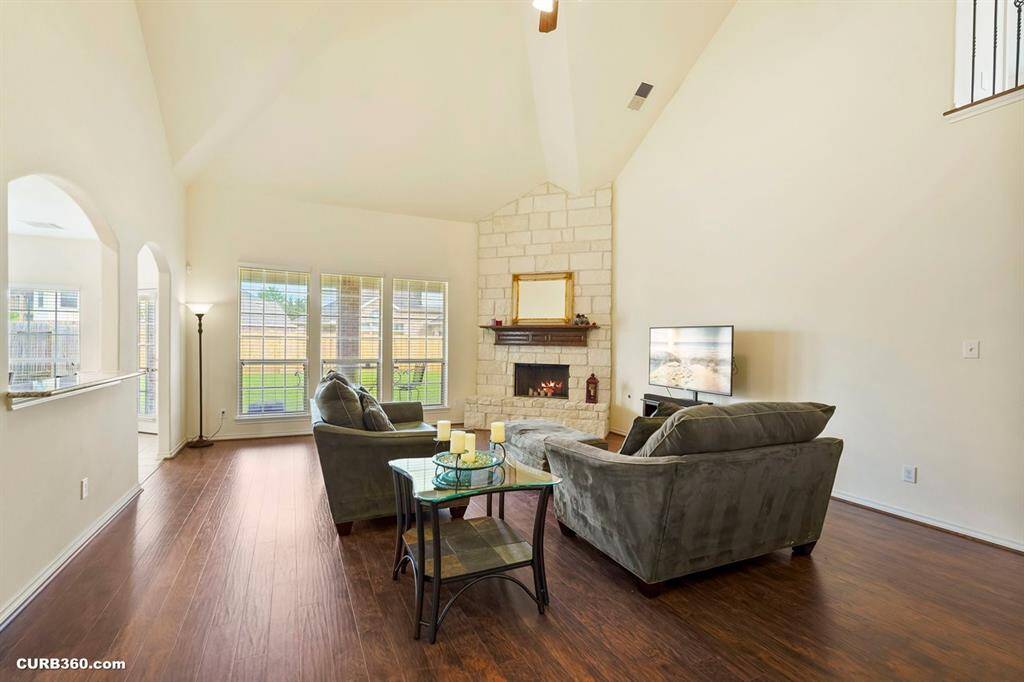 Bright and spacious living room with high ceilings and new laminate floors