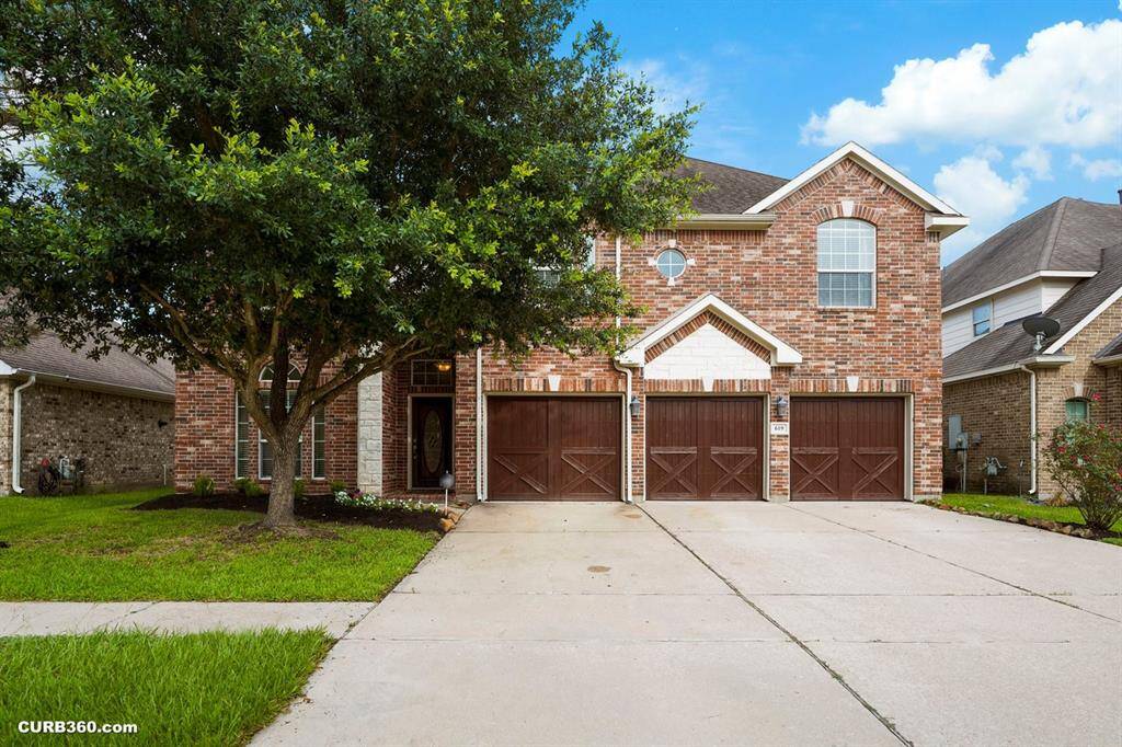 The 3 car garage and driveway offers ample parking