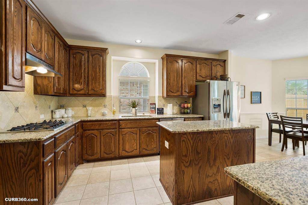 Spacious kitchen ,granite countertops, and a central island