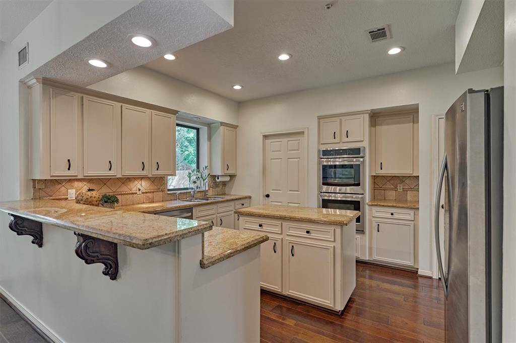 Kitchen with center island. Excellent area prep/cook for the family. Beautiful floors continue. Kitchen is open to Dining and connected to Home Office/Study.