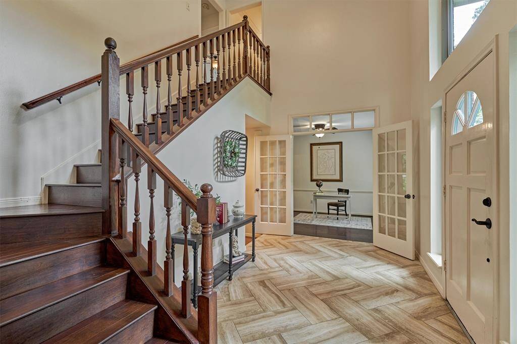 Luxurious staircase with wood treads. Imagine it decorated for the holidays or watching your child make their way down dressed and ready for prom!