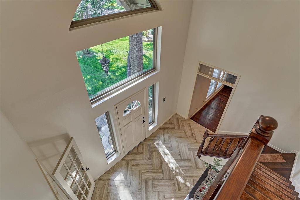 View from upstairs. Tons of natural light. Beautiful herringbone tile floor in entry. Classic beauty!