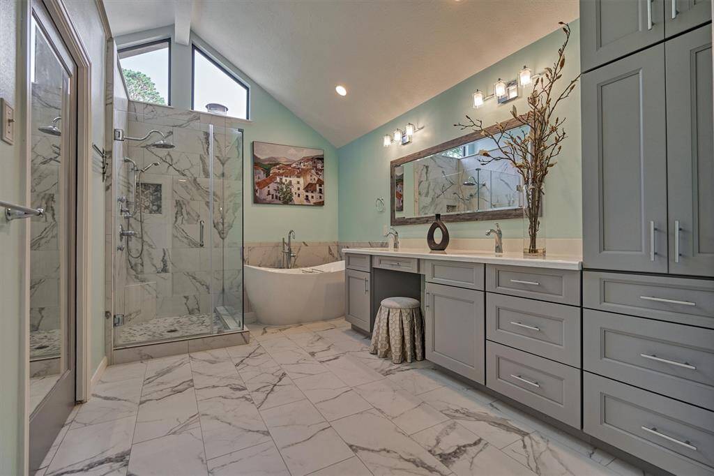 Primary Bath - updated with spa-like finishes. Double sinks with vanity. Soaking tub. Separate Shower.