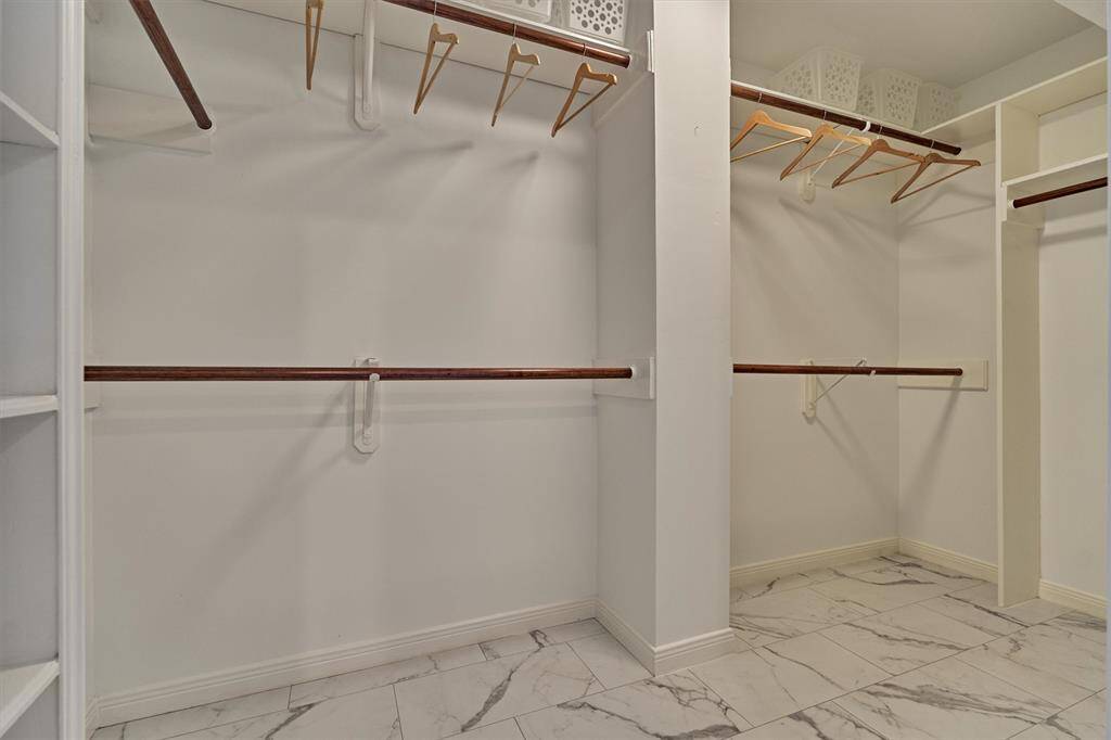Large walk-in closet with plenty of storage.