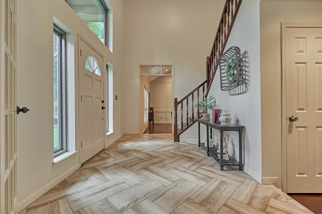 To the left of front door is the Family Room. Transom over door into Family Room. Door is large under-the-stairs storage closet.