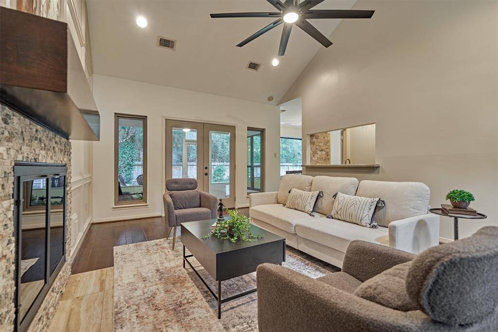 View of Family Room showing connection to screen porch (double doors), Coffee/Wine/Wet bar area and opening to Dining Room.
