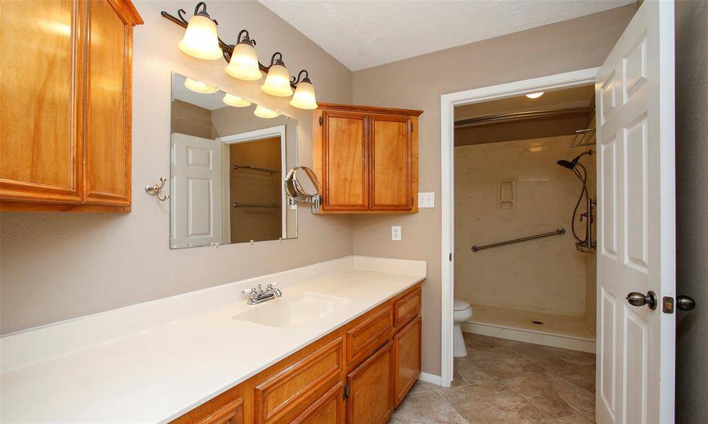 Primary bath with plenty of storage, counter space, and walk in shower