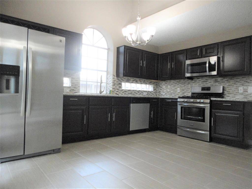 UPDATED KITCHEN WITH RECENT CABINET, SS APPLIANCE, GRANITE COUNTERTOP, LIGHT FIXTURE