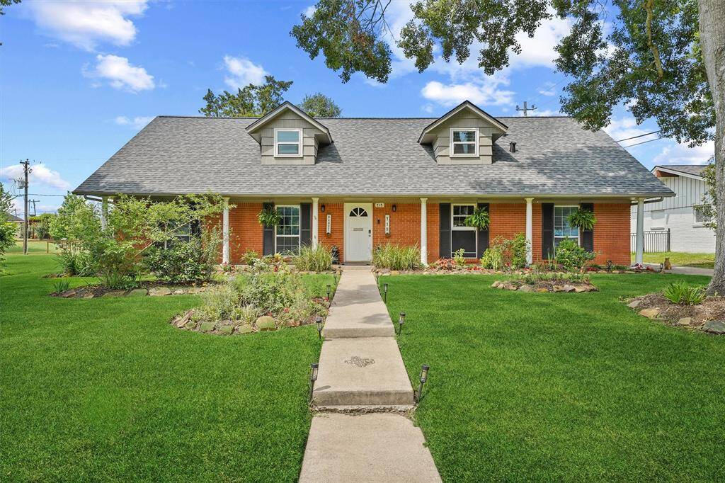 Charming curb appeal with manicured landscaping and a welcoming front porch.