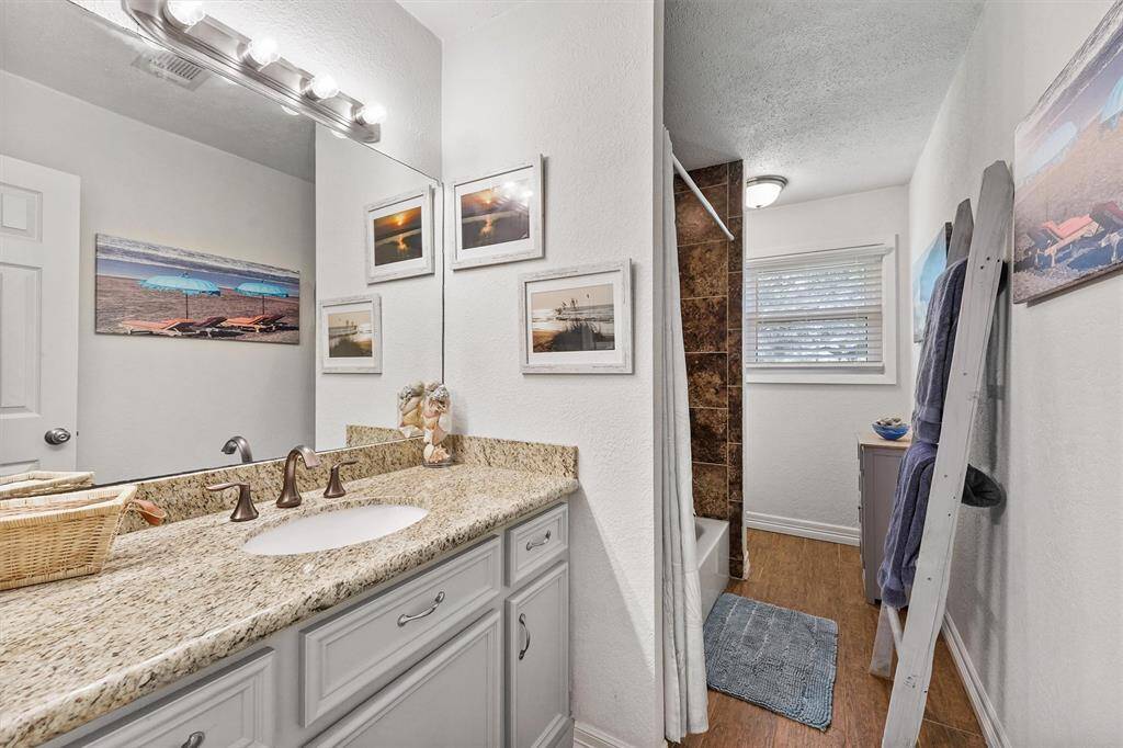 Well-appointed guest bathroom featuring modern fixtures and a tub-shower combo.