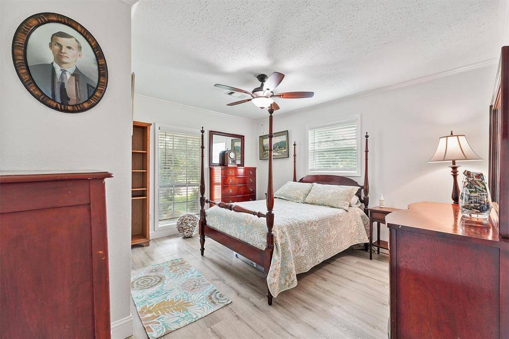 Bright and welcoming guest bedroom with large windows and neutral tones—ready for family, friends, or a cozy home office.
