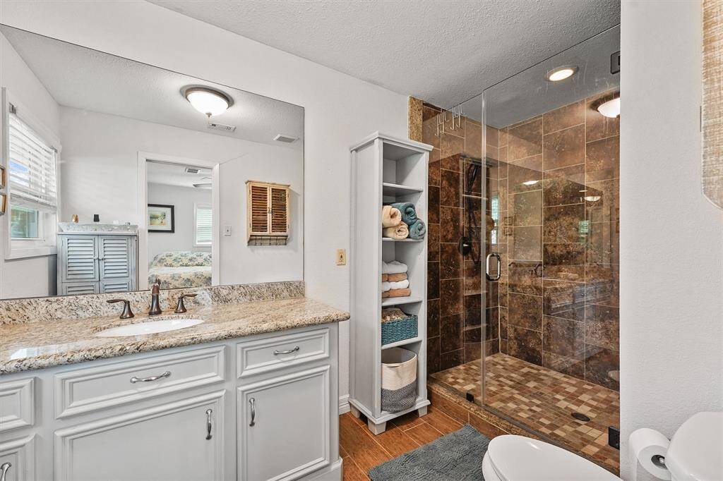 Stylish en-suite bathroom featuring a spacious walk-in shower, updated finishes for a clean, contemporary feel.