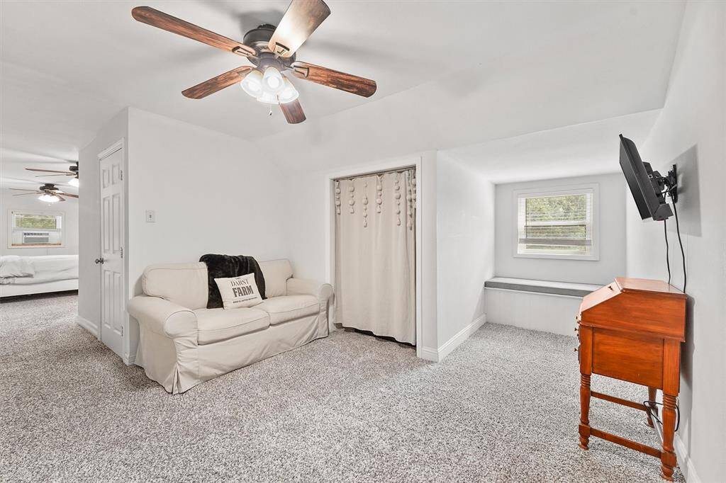Charming upstairs sitting area with inviting nooks and natural light—perfect for reading, lounging, or creating a personalized hideaway.