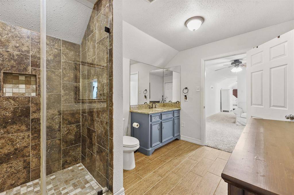 Spacious upstairs bathroom featuring a walk-in shower, modern finishes, and ample room for daily routines or guest use.
