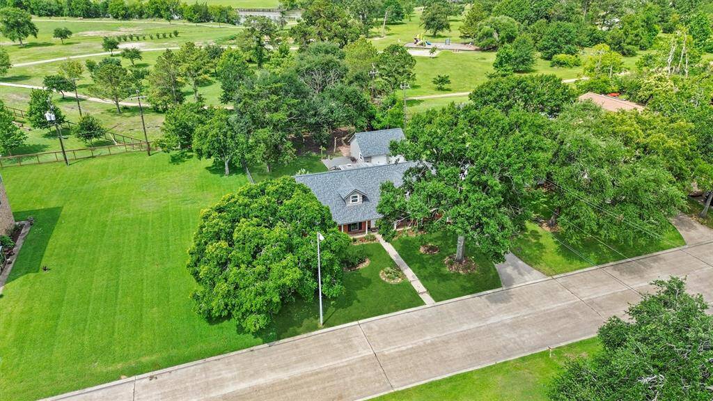 Bird's-eye perspective showcasing the home's spacious lot including the lot next to it.