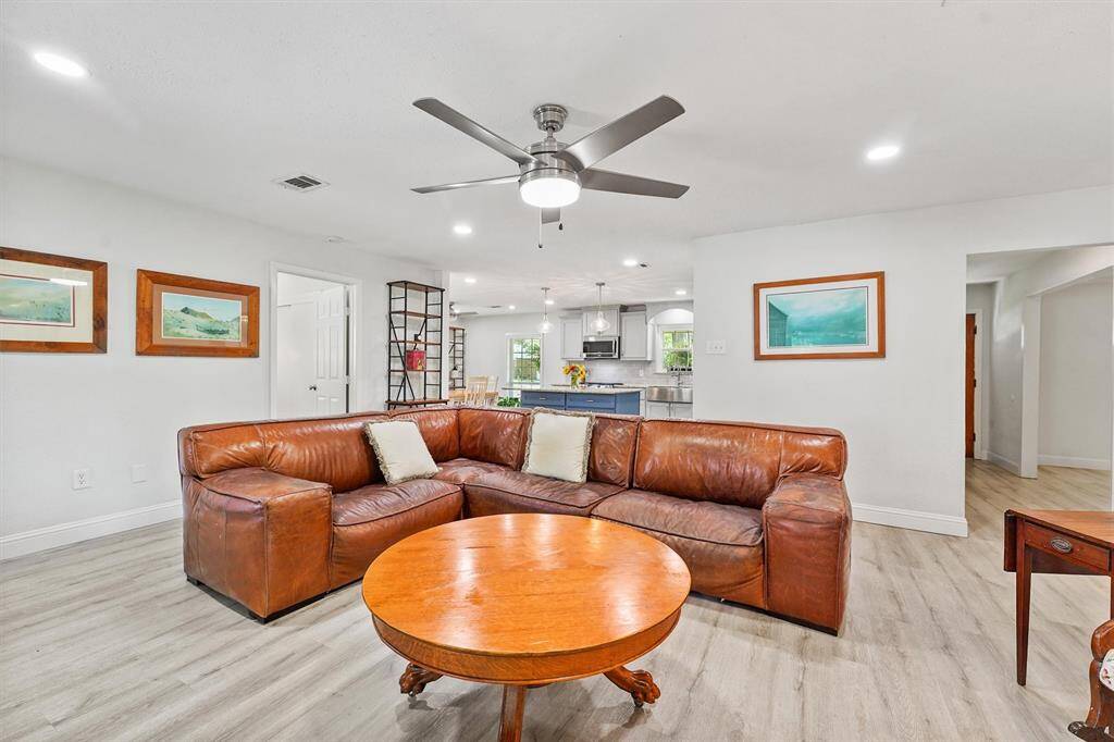 Open-concept living room that seamlessly flows into the kitchen—creating the perfect layout for hosting, and gathering.