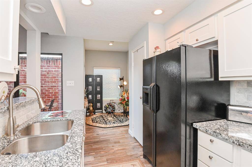 View of kitchen. Refrigerator has been replaced.