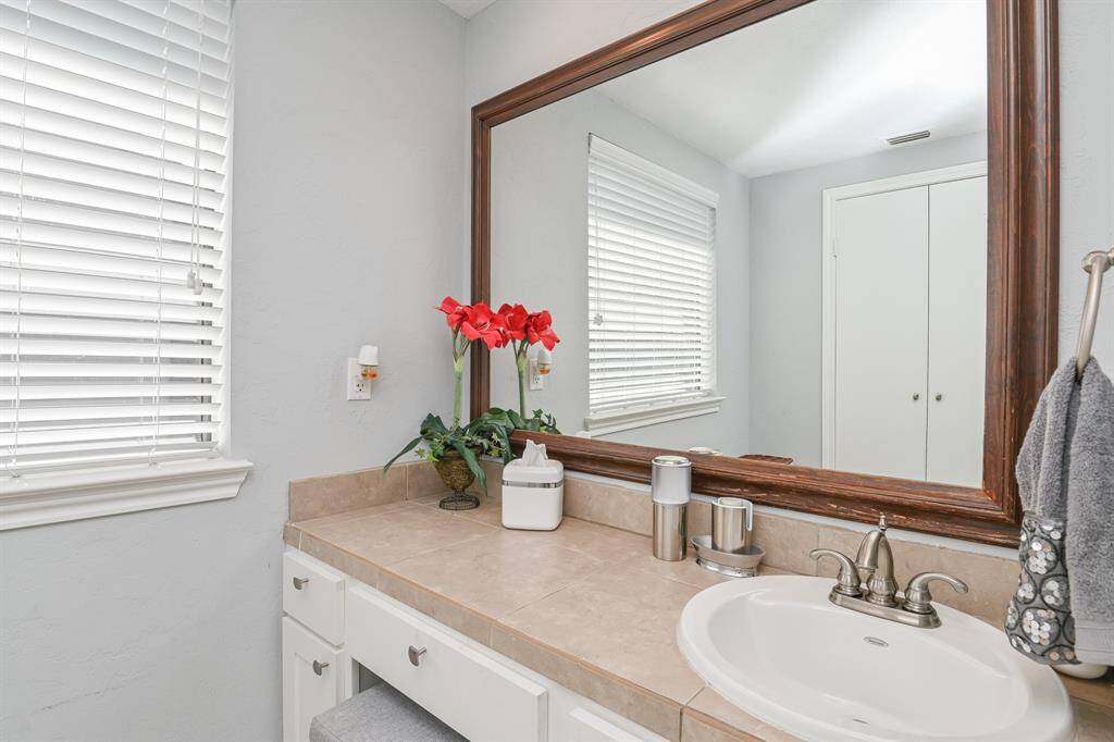 A view of master vanity and has a window for natural light.