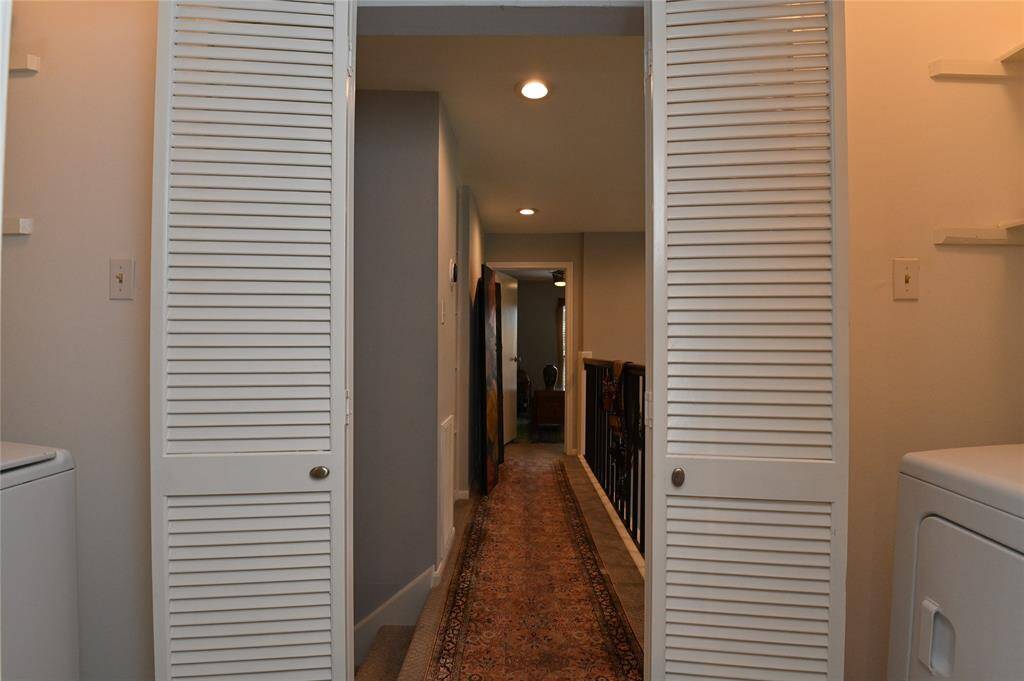 The washer & dryer are located outside of master bedroom to the left and right.