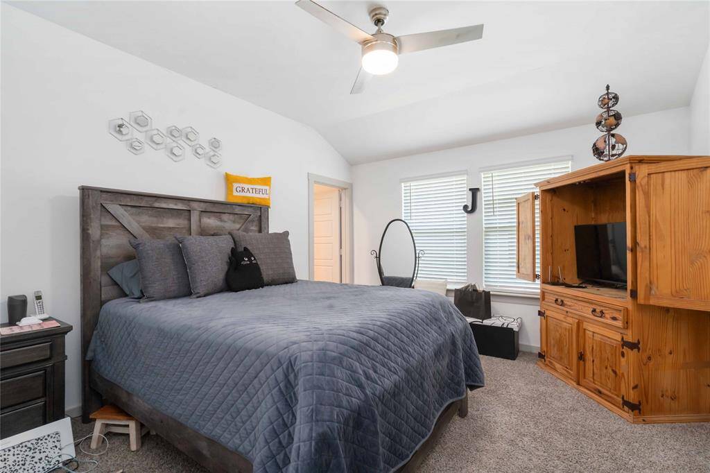 Spacious primary bedroom with tray ceiling, neutral palette, and ample natural light for a peaceful retreat.
