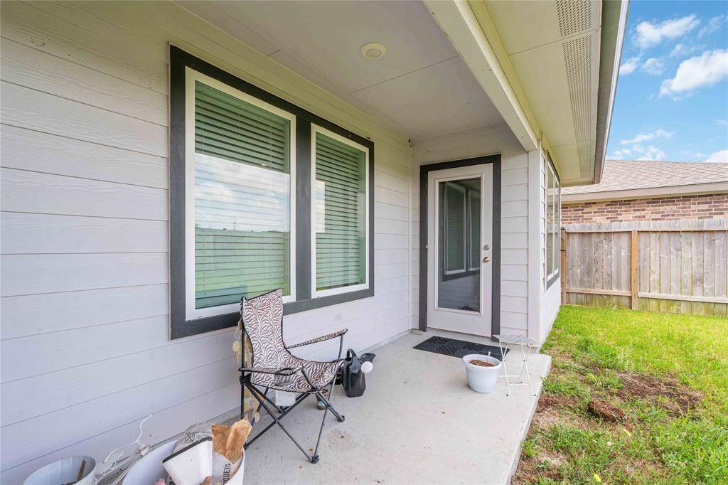 Large covered patio and privacy fencing — ideal for outdoor dining, play, or relaxing evenings.