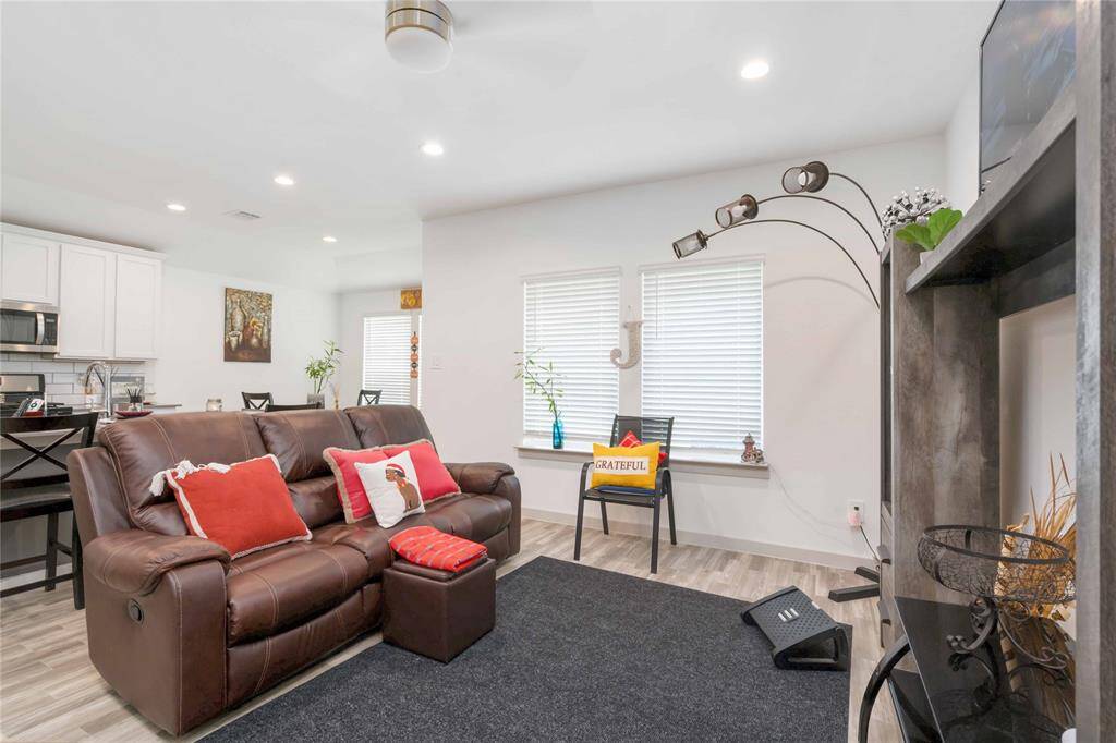 The dining area offers a light-filled setting for meals, with backyard views and seamless access to the kitchen and living spaces.