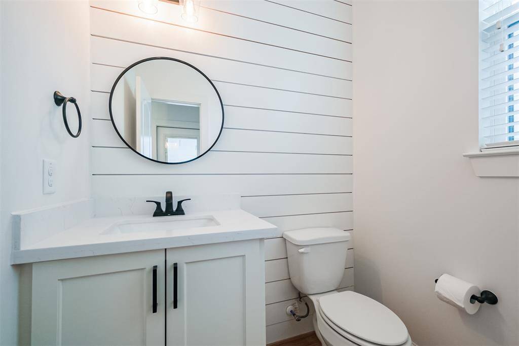 Half bathroom off the kitchen area , but tucked away a bit.