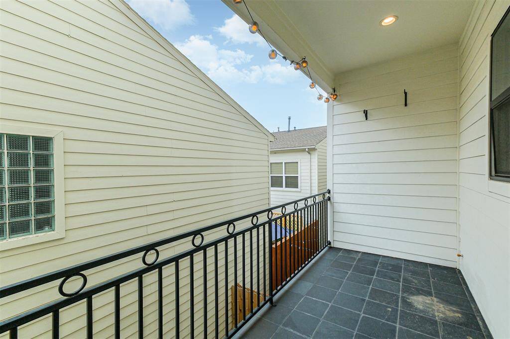 The kitchen window looks out to this back balcony.